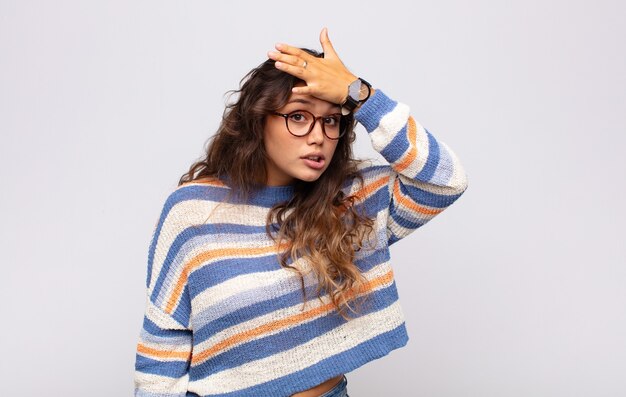 young pretty woman posing against the colored wall