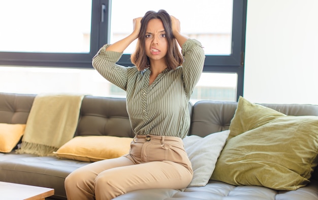 young pretty woman relaxing at home on a couch