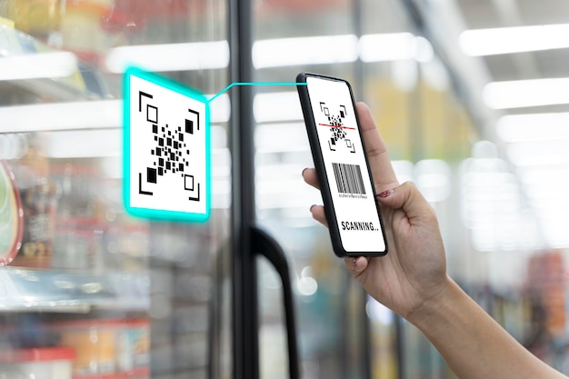 Young pretty woman scans a QR code product in the supermarket The concept of modern technology