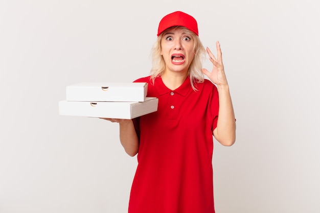 Young pretty woman screaming with hands up in the air. pizza delivering concept