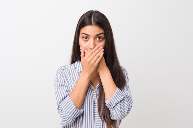 Young pretty woman shocked covering mouth with hands