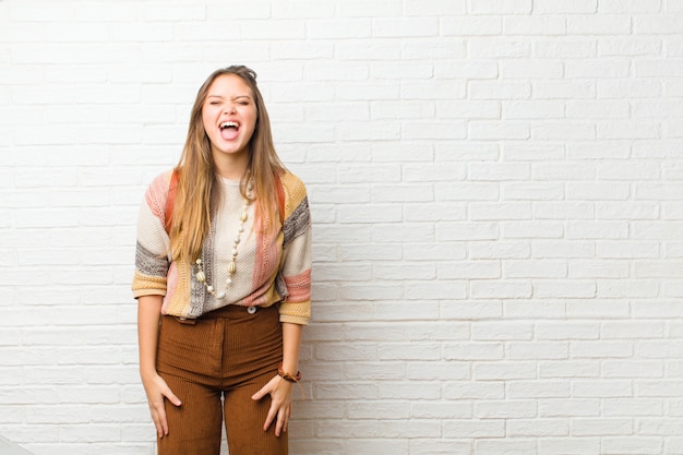 Young pretty woman shouting aggressively, looking very angry, frustrated, outraged or annoyed, screaming no