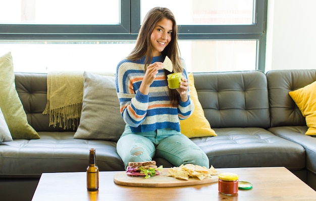 Young pretty woman sitting on a leather sofa