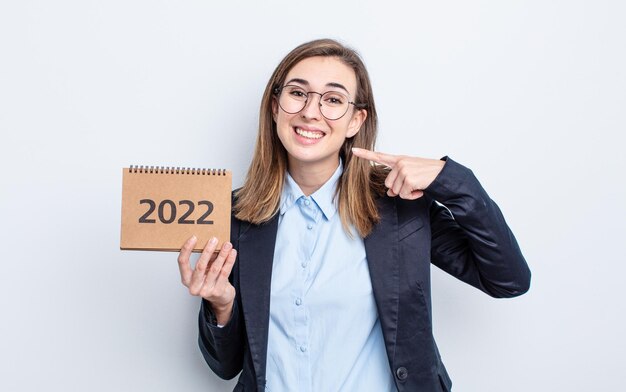 Young pretty woman smiling confidently pointing to own broad smile calendar concept