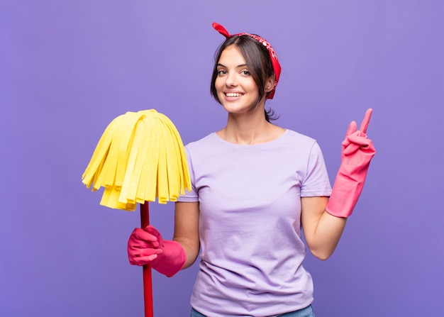 Young pretty woman smiling happily and pointing to side and upwards with both hands showing object in copy space