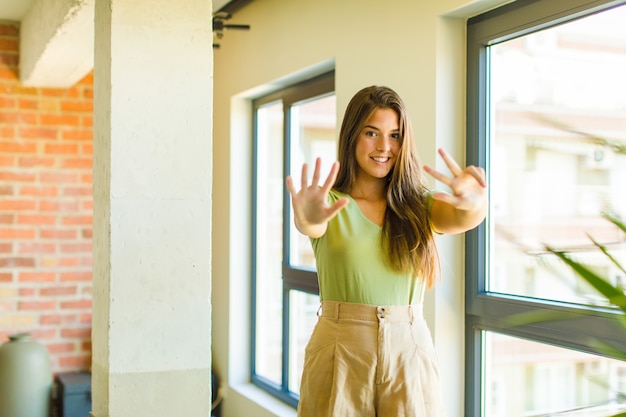 Young pretty woman smiling and looking friendly