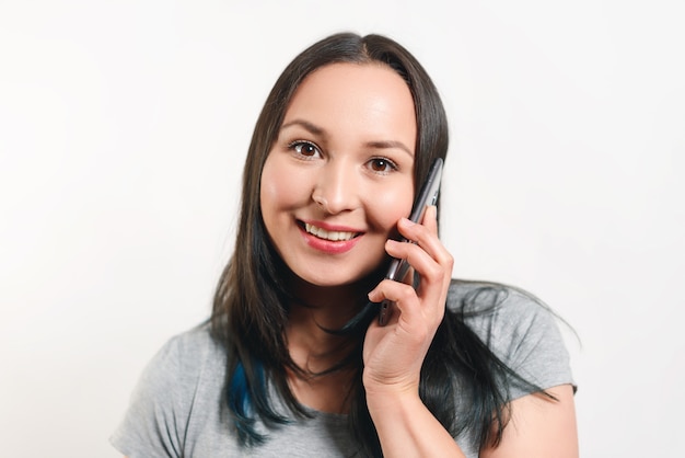 young pretty woman talking on the phone and smiling