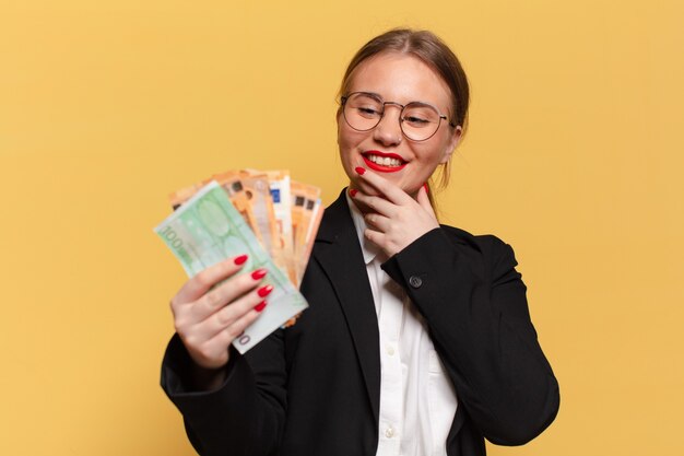 Young pretty woman. thinking or doubting expression euro banknotes concept