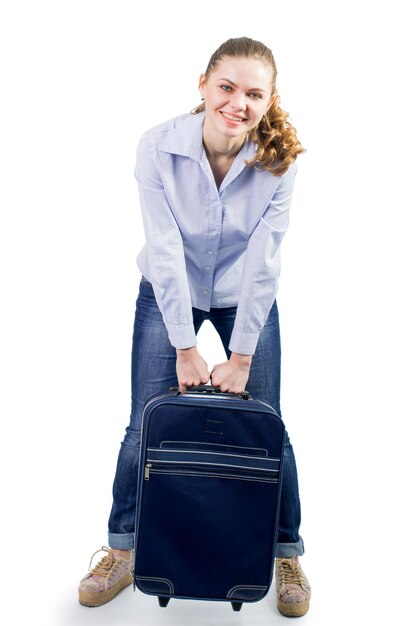 Young pretty woman traveling with big suitcase on the white background