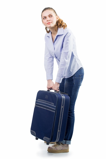 Young pretty woman traveling with big suitcase on the white background