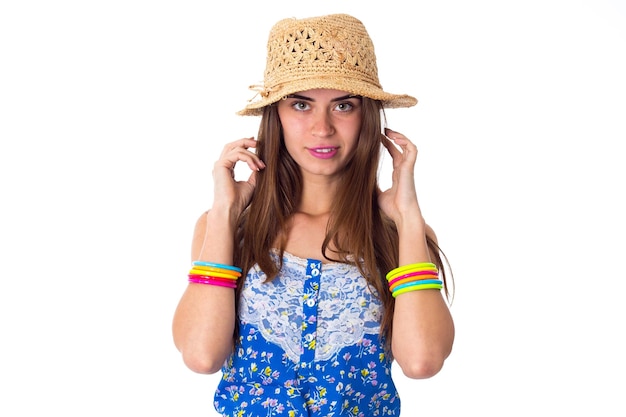 Young pretty woman in Tshirt with colored bracelets smiling and touching her long hair in studio