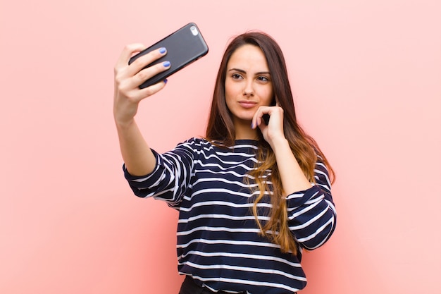 young pretty woman using her smart telephone