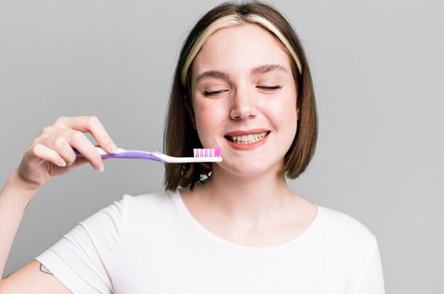 Young pretty woman using a toothbrush