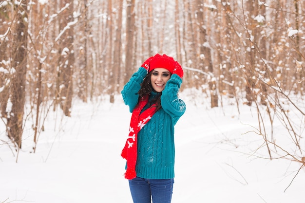 Young pretty woman walking in snowy park