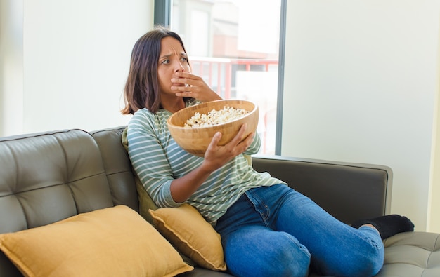 Young pretty woman watching tv at home