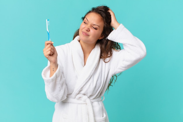 Photo young pretty woman wearing bathrobe