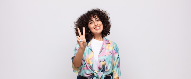 young pretty woman with afro hair doing victory sign