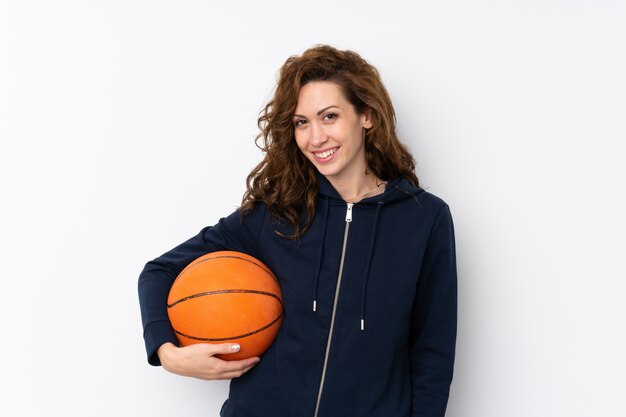 Young pretty woman with ball of basketball