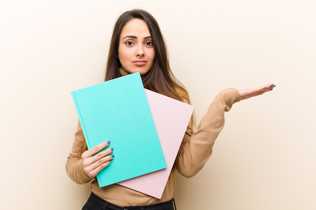 Young pretty woman with books, student concept