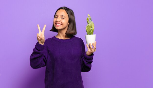 Young pretty woman with a cactus