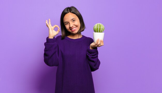 Young pretty woman with a cactus