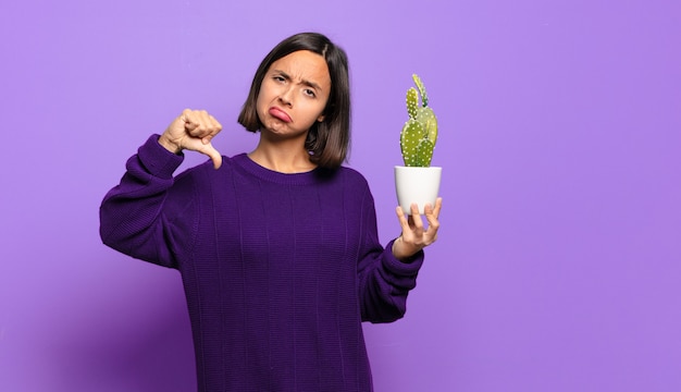 Young pretty woman with a cactus