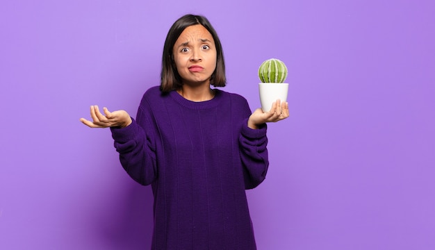 Young pretty woman with a cactus