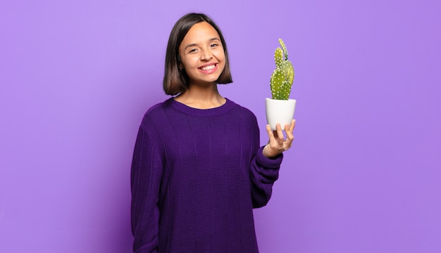 Young pretty woman with a cactus