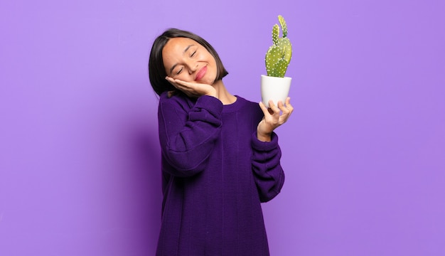 Young pretty woman with a cactus