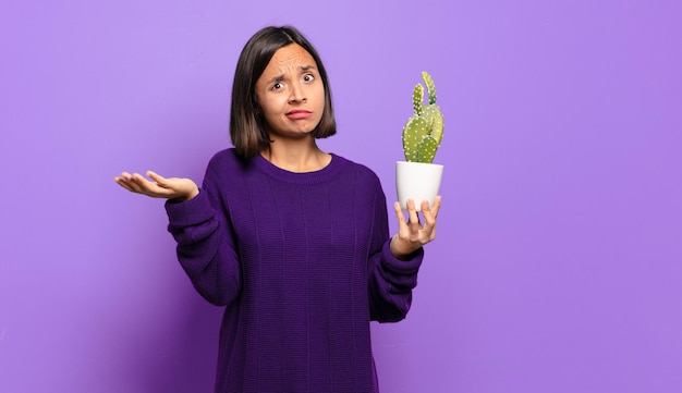 Young pretty woman with a cactus