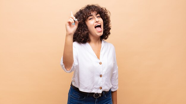 young pretty woman with curly hair and a white shirt