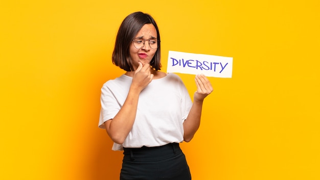 Young pretty woman with diversity board