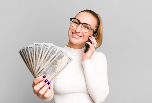 Young pretty woman with dollar banknotes and a smartphone