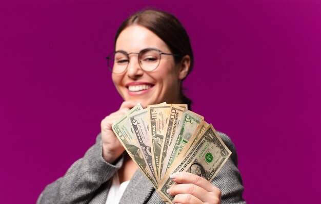 Young pretty woman with dollar banknotes