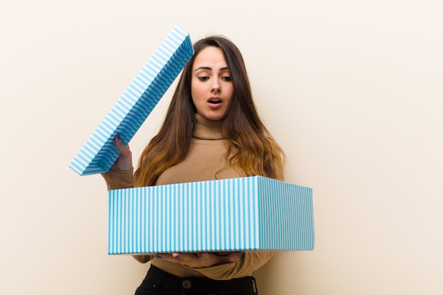 Giovane donna graziosa con confezione regalo