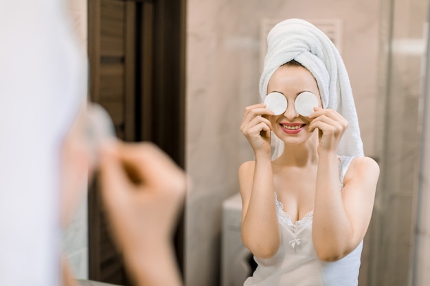 Young pretty woman with head wrapped in towel