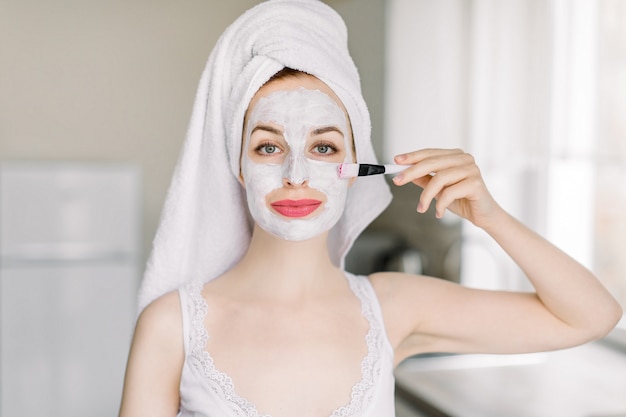 Young pretty woman with head wrapped in towel