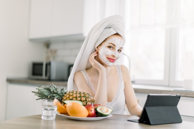 Young pretty woman with head wrapped in towel