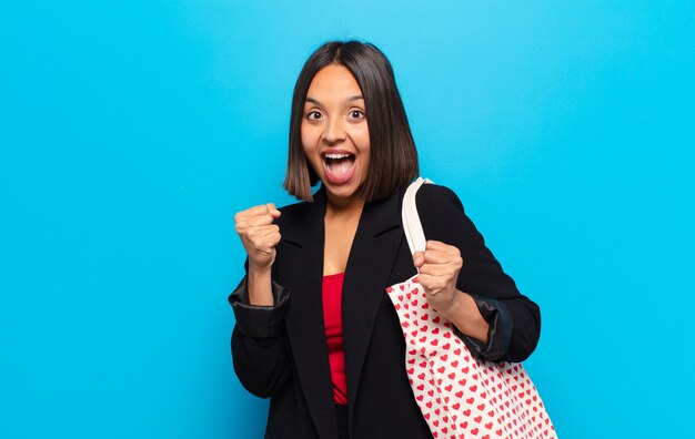 Young pretty woman with a hearts bag