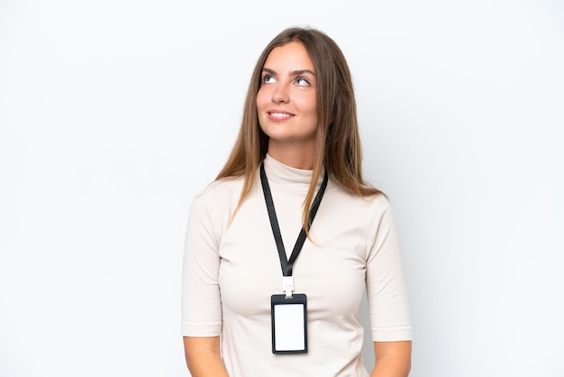 Photo young pretty woman with id card isolated on white background thinking an idea while looking up