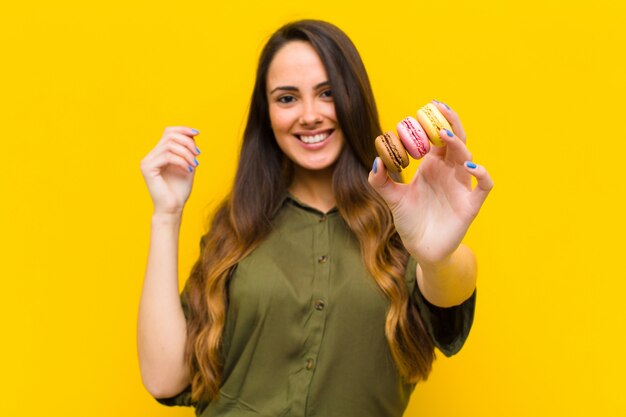 Young pretty woman with macaroons.