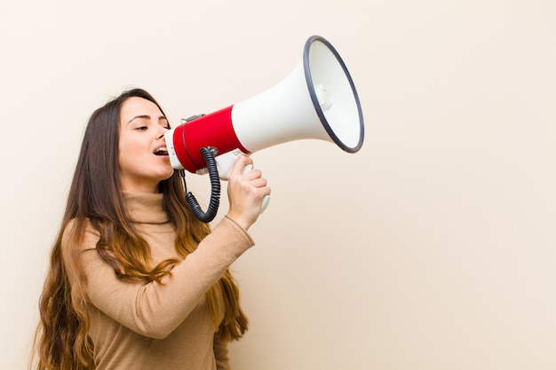 Young pretty woman with a megaphone