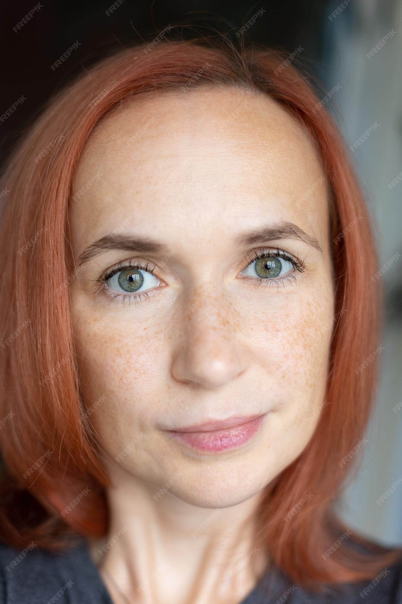 Premium Photo | Young pretty woman with red hair green eyes and freckles looks at the camera and smiles closeup selective focus Premium Photo | Young pretty woman with red hair green eyes and freckles looks at the camera and smiles closeup selective focus