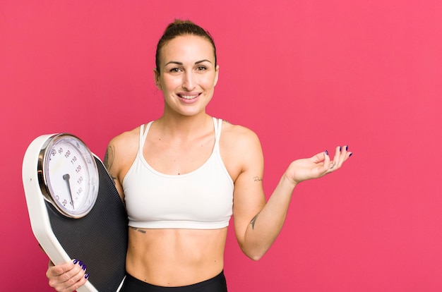 Young pretty woman with a scale diet and fitness concept