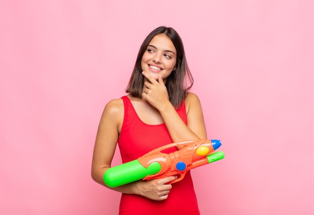 young pretty woman with a water gun