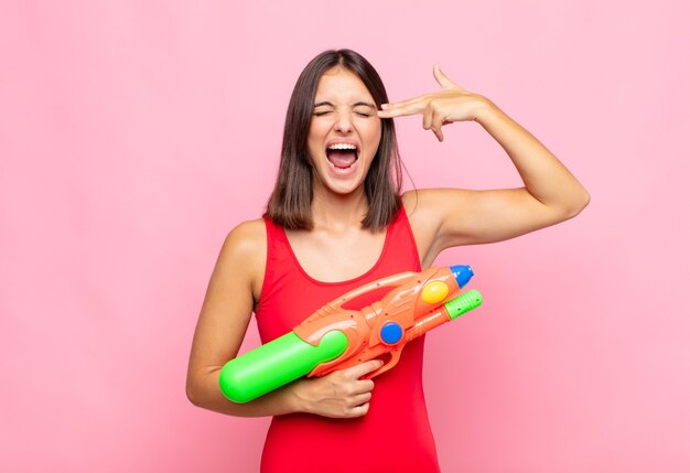 young pretty woman with a water gun