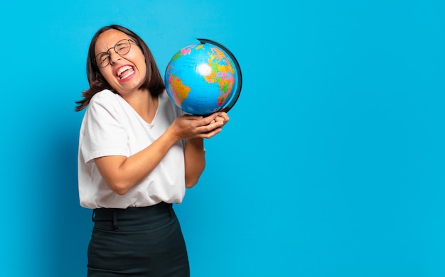 Young pretty woman with a world globe map