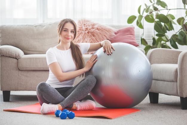 Young pretty woman working out at home