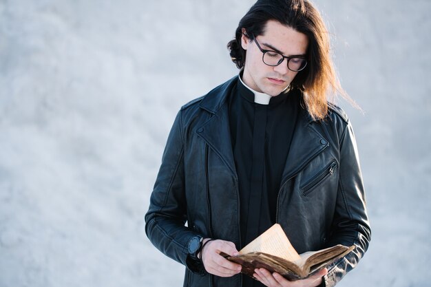 Young priest portrait outside at sunset.