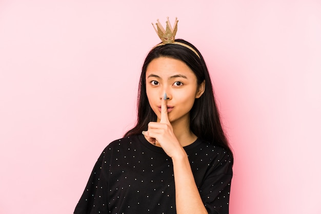 Young princess woman on a pink showing number two with fingers.